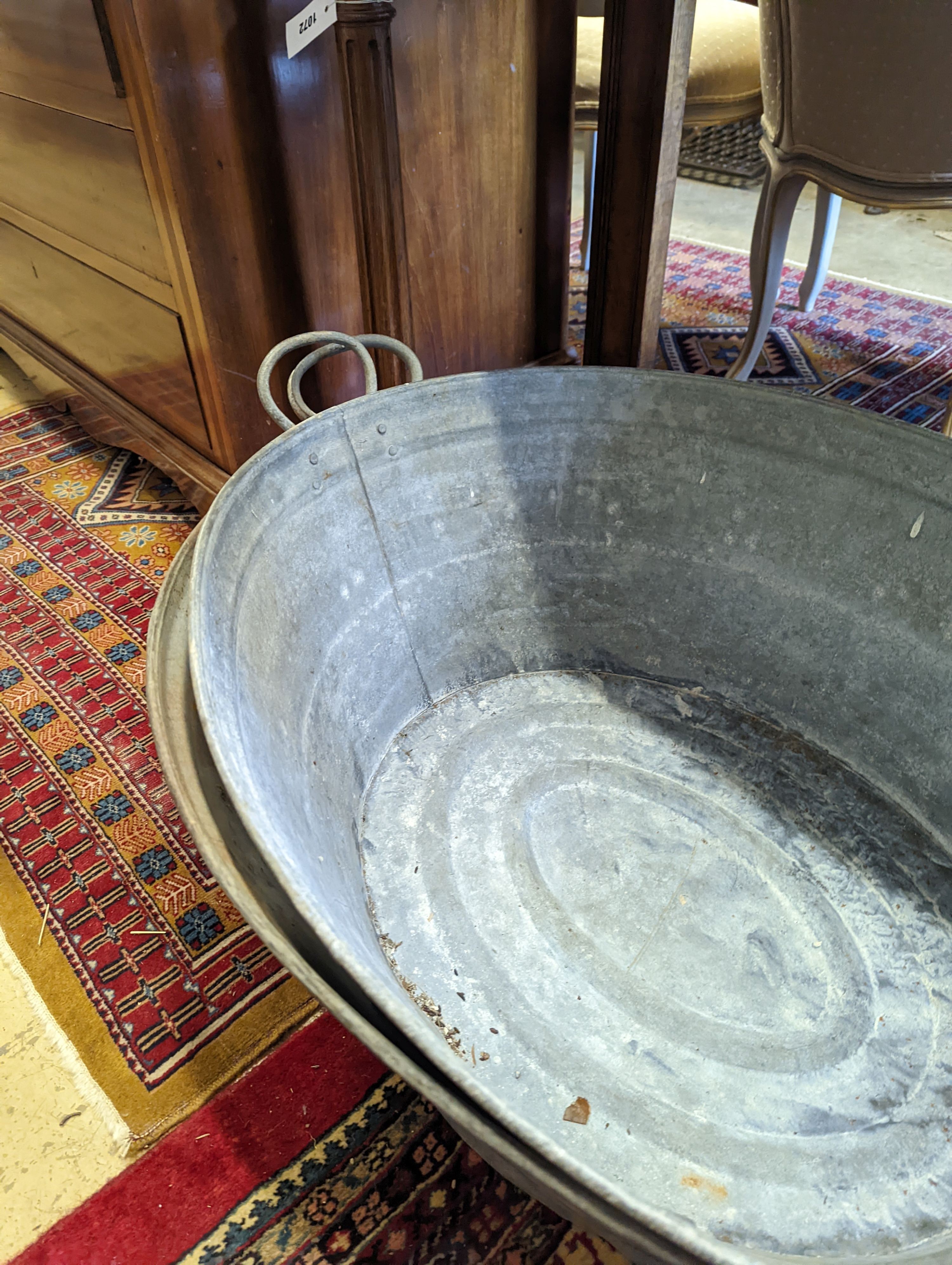 Two large oval galvanised tubs, larger width 89cm